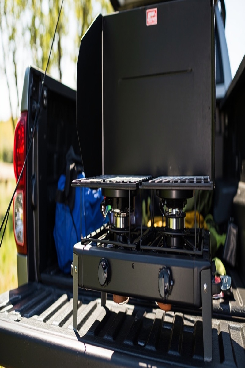 Camp Chef Explorer 2-Burner with three-sided windscreen on a tailgate